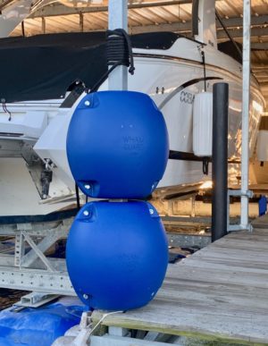 Two Blue Rotating Boat Dock Bumpers attached on a boat dock post