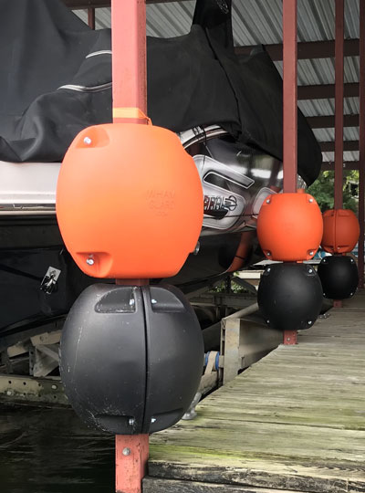Orange and Black WhamGuard Rotating Bumpers mounted on dock post