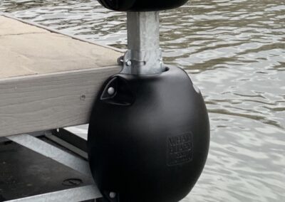 Black Below the Deck Dock Bumper attached to boat dock